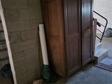 an image of an unfinished garage with a wooden armoire