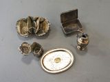 a silver tray and other silver objects on a table