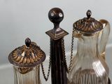 three silver and glass items sitting on a table