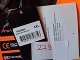 an orange vest with a tag on it next to a pair of scissors and a pair of scissors