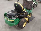 a picture of a lawn mower parked in a lot