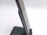 a cell phone that is sitting on top of a stand