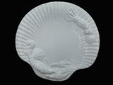white plate with a decorative design on it on a black background