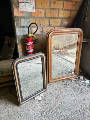 two mirrors sitting on the ground next to a fire hydrant