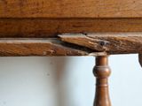 a close up of a wooden table with a piece of wood sticking out of it