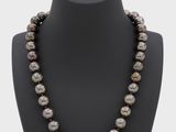 a black and white pearl necklace on a mannequin mannequin