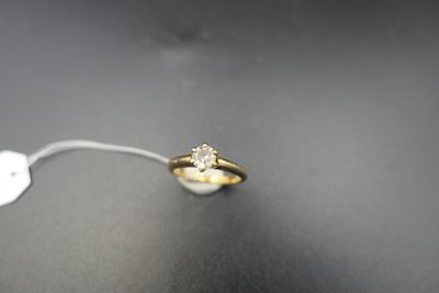 a close up of a gold ring with a diamond on it