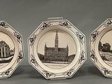 three plates with a picture of a building and a clock on them