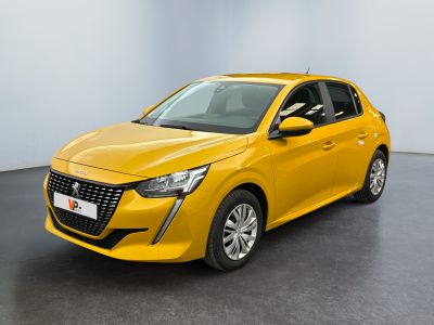 Une voiture jaune est garée dans une pièce blanche au sol noir.