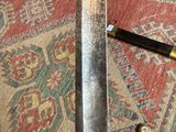 a person holding a knife in their hand on a rug