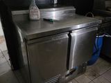 a stainless steel counter with a bottle of water on it