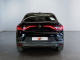 the rear end of a black car in a white room