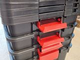 a close up of a stack of black and red tool boxes