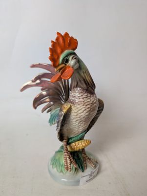 a figurine of a rooster on a pedestal