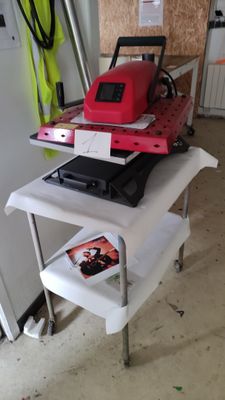 a table with a laptop and a printer on it