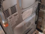 a picture of a dishwasher in the middle of a pile of boxes