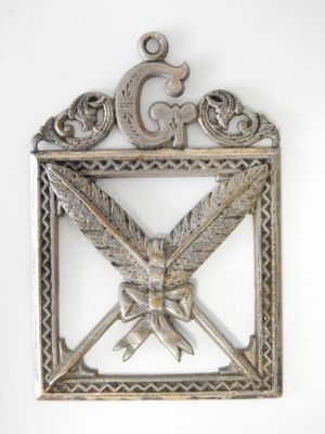 an image of a silver metal plaque with a bird on it