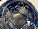 a glass vase with a clock inside of it on a table