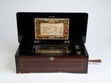 a small musical box with a note inside of it