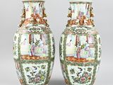 pair of chinese vases with figures on them on a gray background