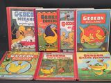 Plusieurs livres pour enfants sont alignés sur une surface noire