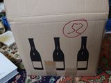 a cardboard box that has three bottles of wine in it