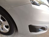 a close up of a car ' s front bumper and tire