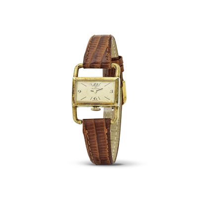 une photo d'une montre en or avec un bracelet en cuir marron