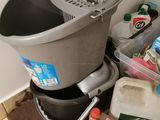 a bucket of cleaning products on the floor next to a bucket of cleaning products