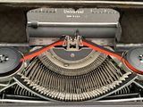 an old typewriter with a red ribbon on it