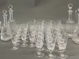 a lot of wine glasses and a pitcher on the table