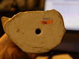 a person holding a piece of paper with a sticker on it