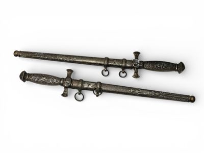 two antique swords with metal handles on a white background