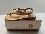 someone is wearing a pair of sandals that are on top of a box