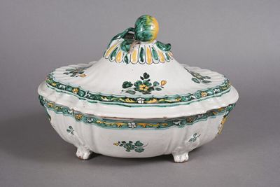a white bowl with a green and yellow decoration on it