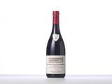 the bottle of red wine is sitting on the table