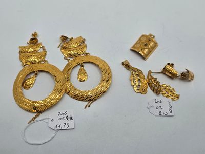 two pairs of gold earrings and a pair of gold earrings