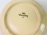 a yellow plate with a black stamp on it