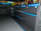 empty shelves in a store with blue and white labels on them