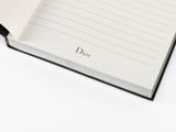 dior notebook in black and white with the word dior written on it