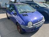 a small blue car that is parked in a parking lot