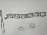 an image of a bracelet, ring, and earring laying on a table