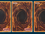 three cards with a picture of a black hole in the middle of them