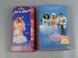 two barbie and dream dolls are on display on a table