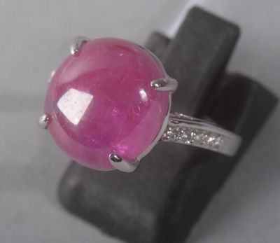 an image of a ring with a pink stone and diamonds on it