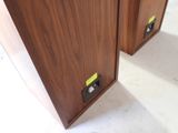 two wooden cabinets that have yellow tags on them