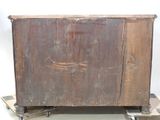 an old wooden cabinet on wheels on the floor