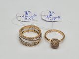 two gold rings and a diamond ring with price tags on them