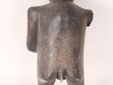 an image of a statue of a person standing with his back to the camera