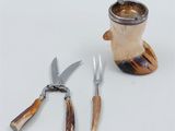 a knife, fork, and a knife holder next to each other